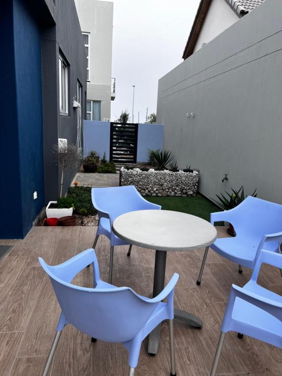 a patio with a white table and chairs at 5078 Swakopmund in Swakopmund