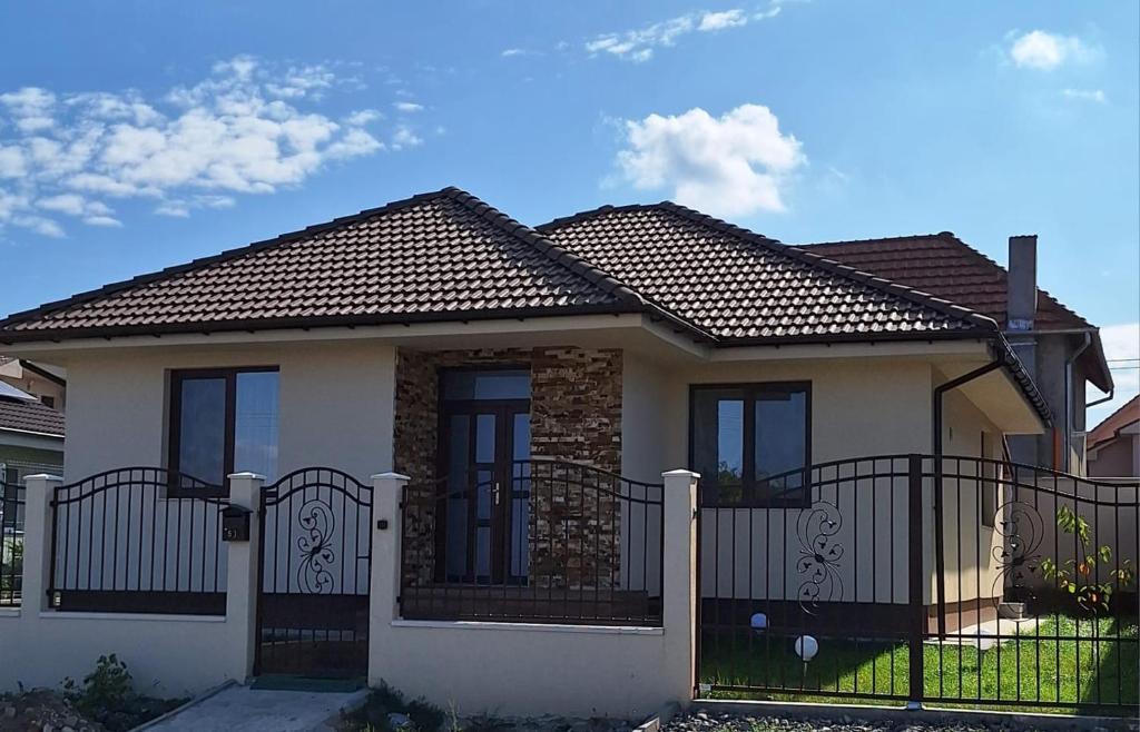 a house with a fence in front of it at Casa de langa lac in Oradea