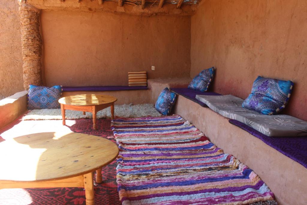 a living room with a couch and a table at Kasbah Desert Camp in Mhamid