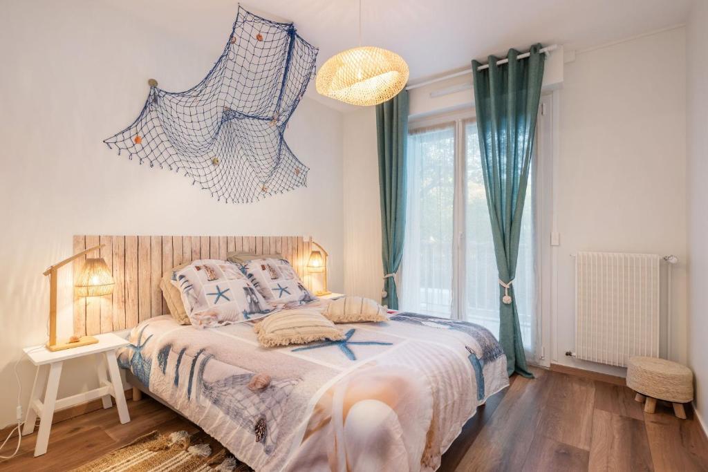 a bedroom with a large bed with blue curtains at Beach Resort - Casa Vostra - CAUTION 800 EUR & ID requises - Saint Julien Centre-Gare in Saint-Julien-en-Genevois
