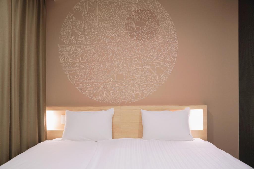 Postel nebo postele na pokoji v ubytování Park Central Sakura Hotel