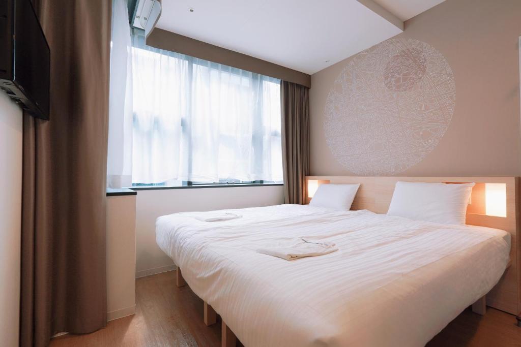 Postel nebo postele na pokoji v ubytování Park Central Sakura Hotel