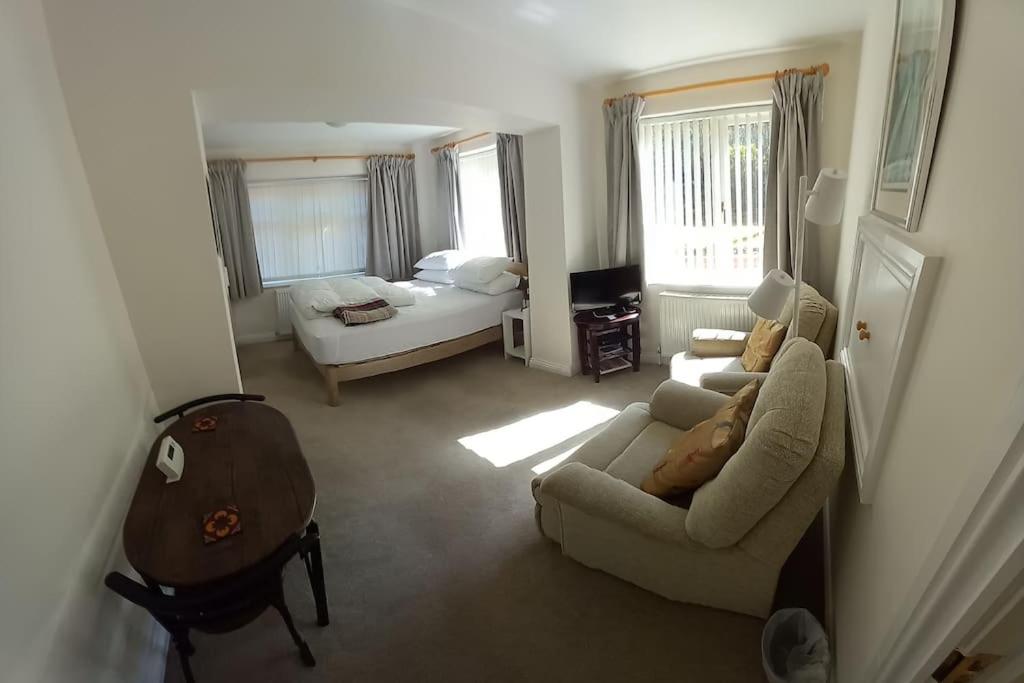 a living room with a couch and a bed at The Side - Hexham in Hexham