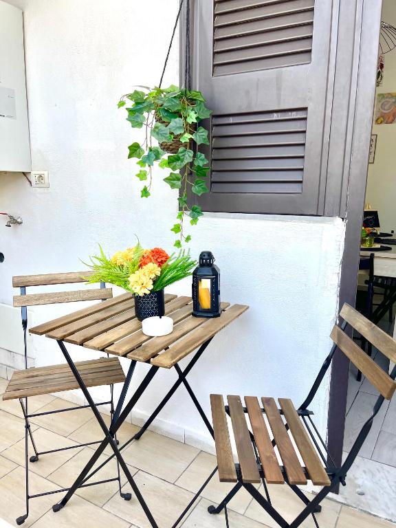 a table with flowers on it next to two chairs at House Capodichino in Naples