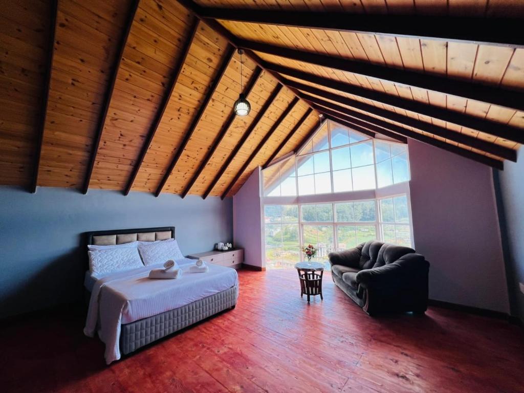 a bedroom with a bed and a large window at Villa Moon Light Nuwara Eliya in Nuwara Eliya