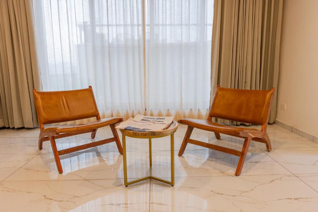 two chairs and a table in a room at SURAMYA-A Luxury Boutique Hotel in Udaipur