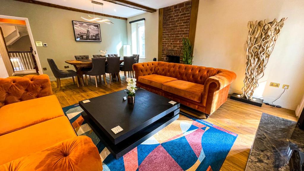 a living room with a couch and a table at The Coach House - Your luxury private Brighton getaway with private parking in Brighton & Hove