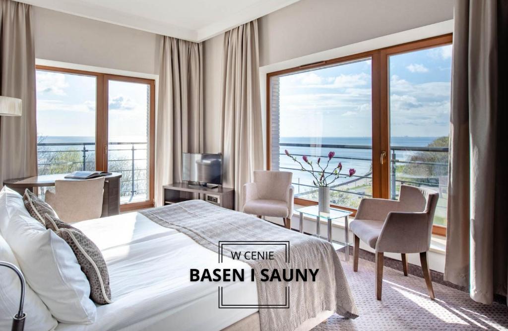 a bedroom with a bed and a view of the ocean at Hotel Różany Gaj in Gdynia