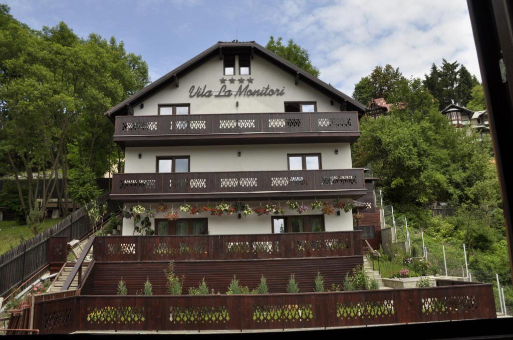 a building with a sign on the side of it at La Monitori in Sinaia