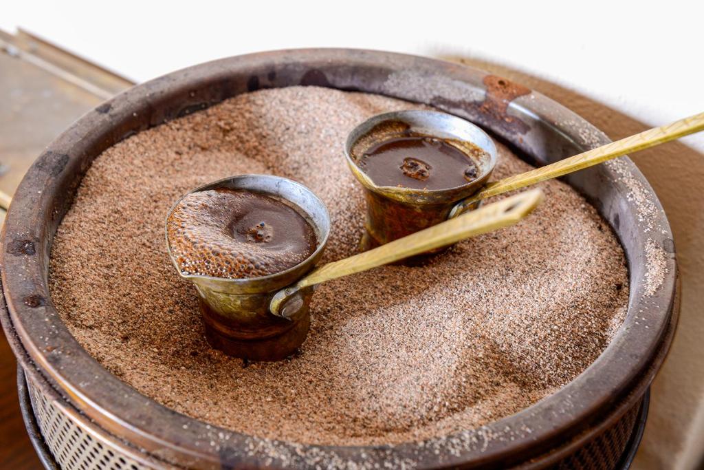 a pot filled with dirt with chop sticks in it at Varos Village Boutique Hotel in Város