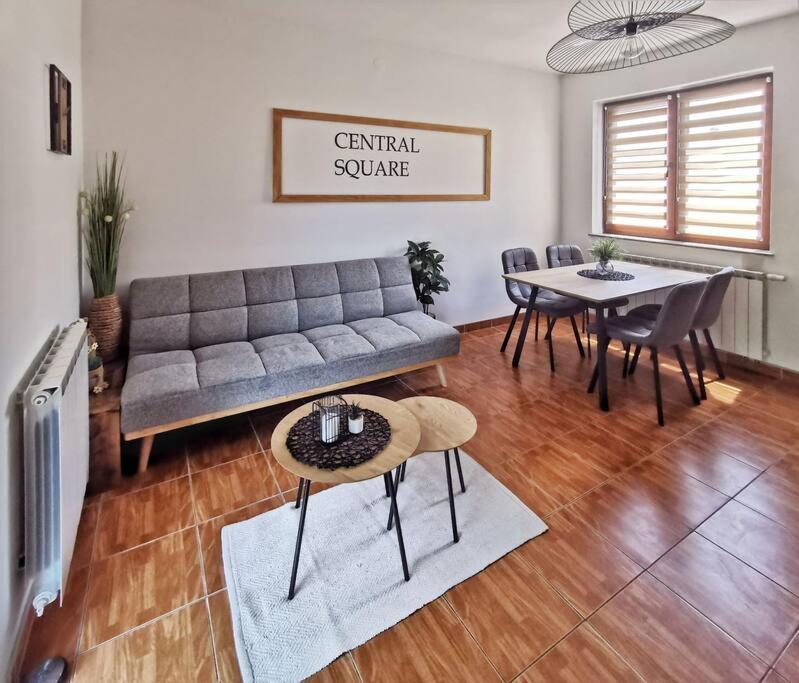 a living room with a couch and a table at Apartman Central Square in Gospić