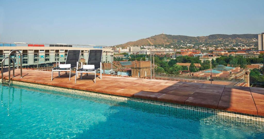 a swimming pool on the roof of a building at NH Barcelona Stadium in Barcelona