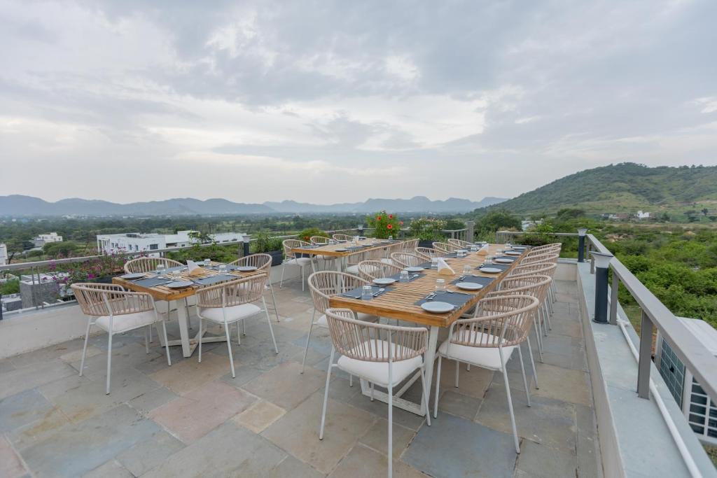 a row of tables and chairs on a balcony at SURAMYA-A Luxury Boutique Hotel in Udaipur