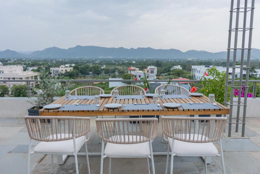 a wooden table and chairs on top of a roof at SURAMYA-A Luxury Boutique Hotel in Udaipur
