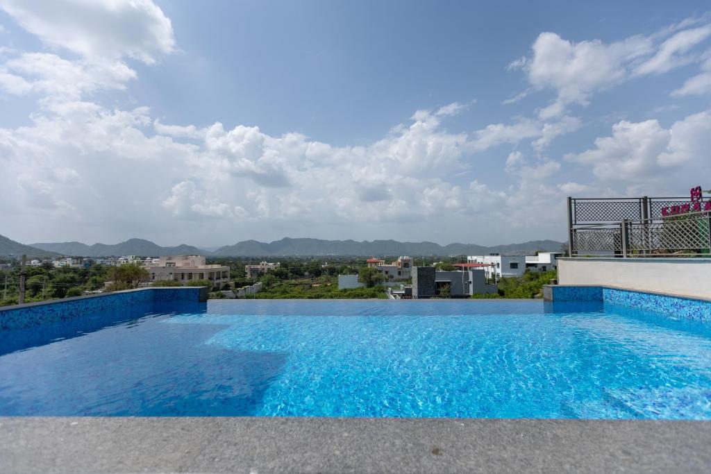 a swimming pool on the roof of a building at SURAMYA-A Luxury Boutique Hotel in Udaipur