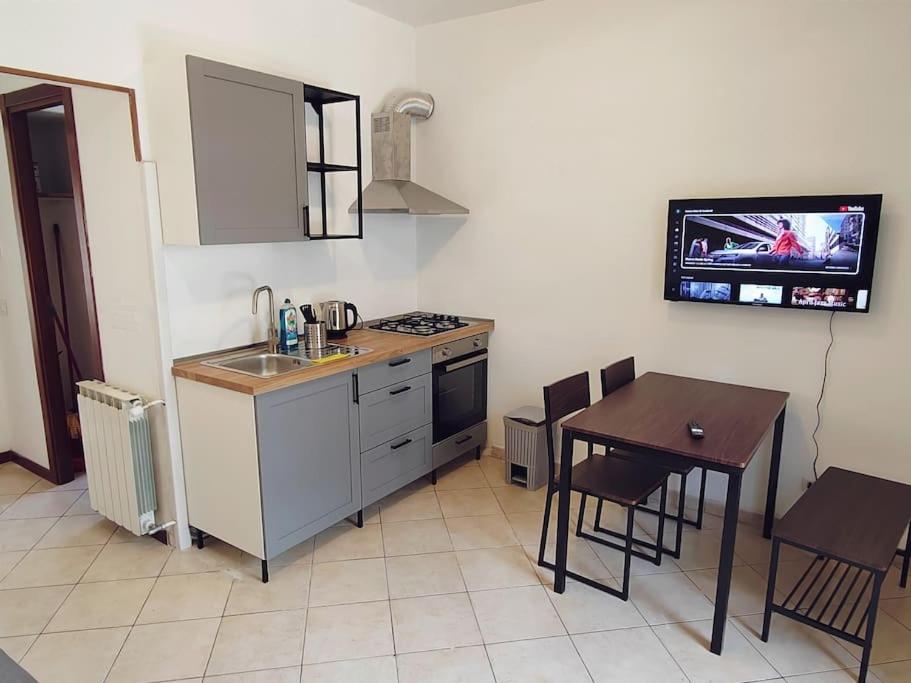 a kitchen with a table and a sink and a stove at Casa Aurelia in Rome