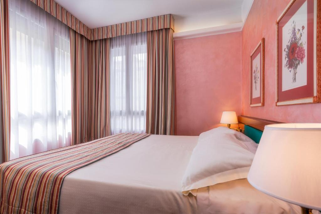 Postel nebo postele na pokoji v ubytování Hotel Crivi's