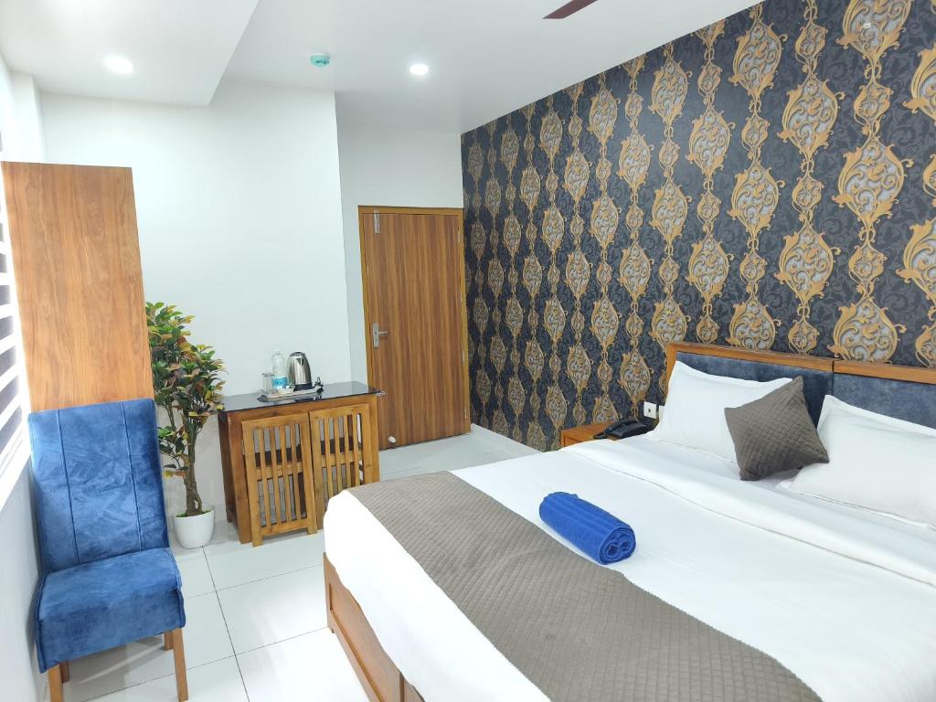 Postel nebo postele na pokoji v ubytování Wayanad Palace