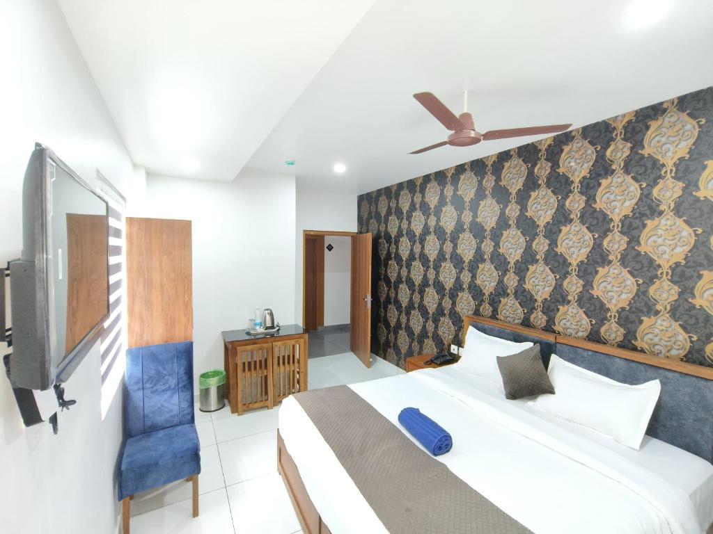 Postel nebo postele na pokoji v ubytování Wayanad Palace
