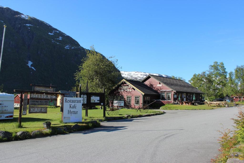 a street with houses on the side of a mountain at Skysstasjonen Cottages in Røldal