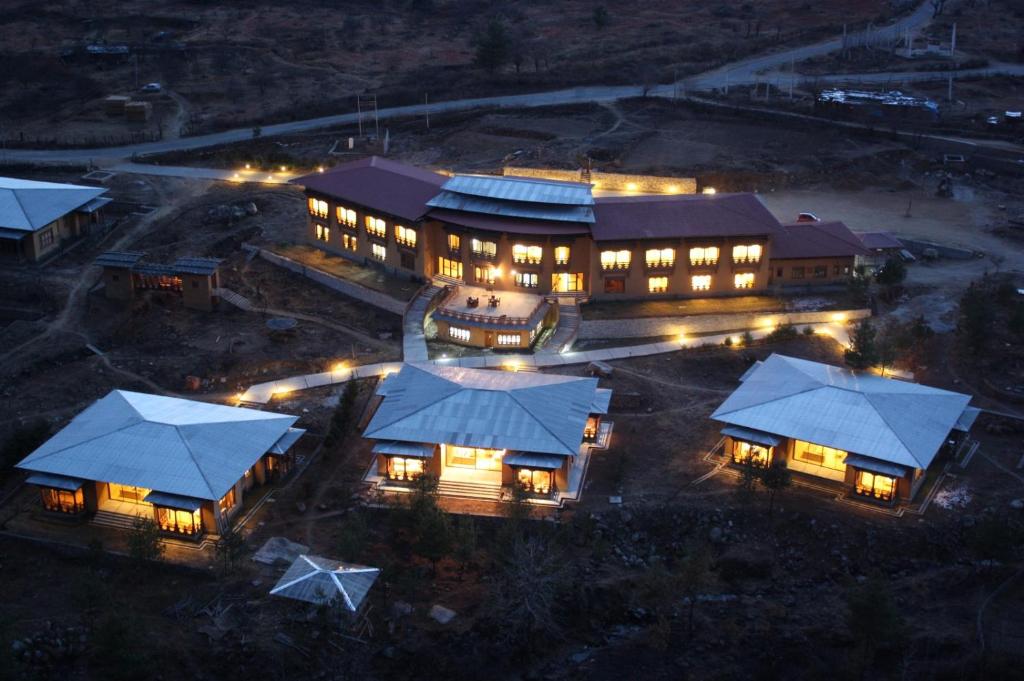 an overhead view of a large building at night at Udumwara Resort in Paro