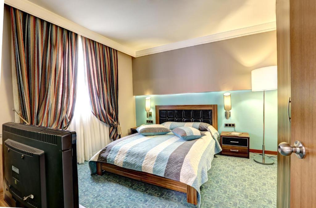 A bed or beds in a room at Suhan Cappadocia Hotel & Spa