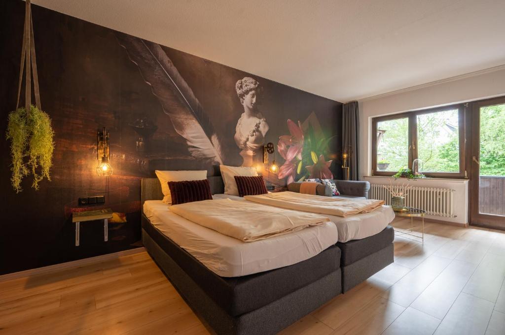 a bedroom with two beds and a painting on the wall at Zur Schmitte in Schmallenberg