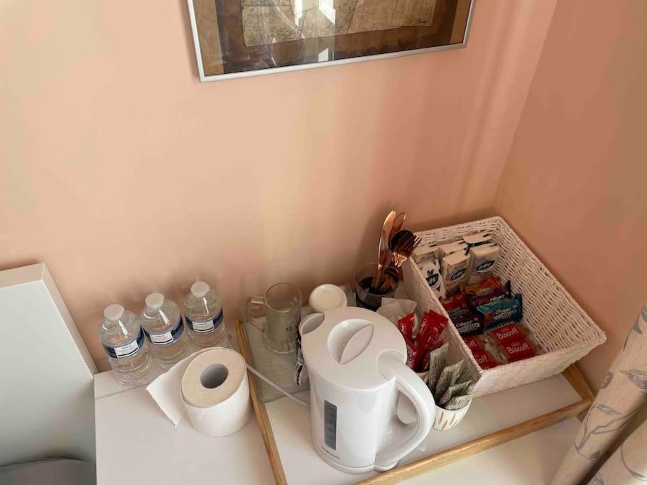 a counter with a shelf with water bottles on it at Sunny 1bedroom flat for rent. in London