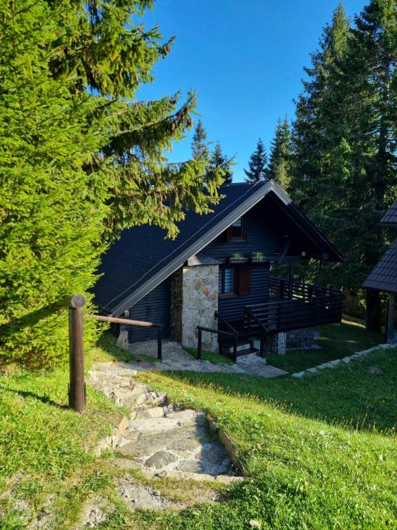 a log cabin with a pathway in front of it at Apartment Bajta - Rogla in Zreče