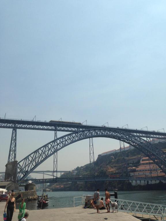 a bridge over the water with people and dogs at Residencial clérigos ROOM 3 in Porto