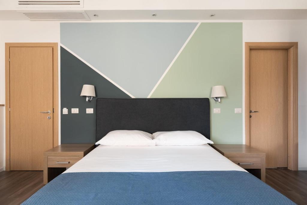 a bedroom with a large bed with a black headboard at Fleming Suites in Rome