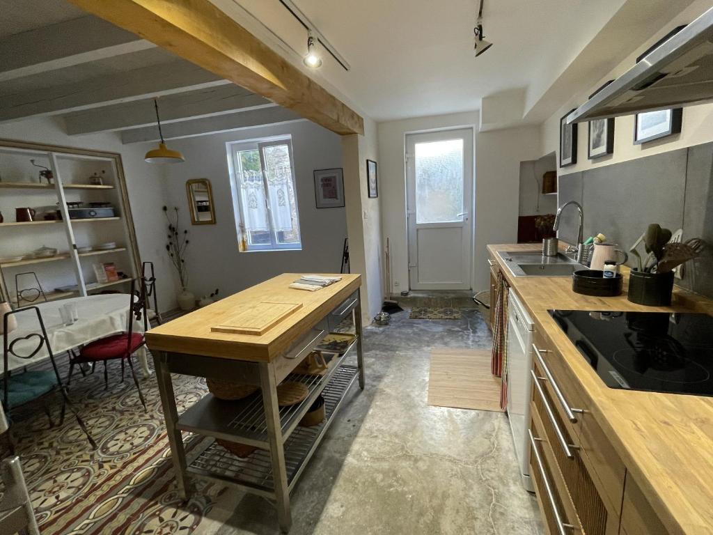 a kitchen with a table and a counter top at Le Taurillou 