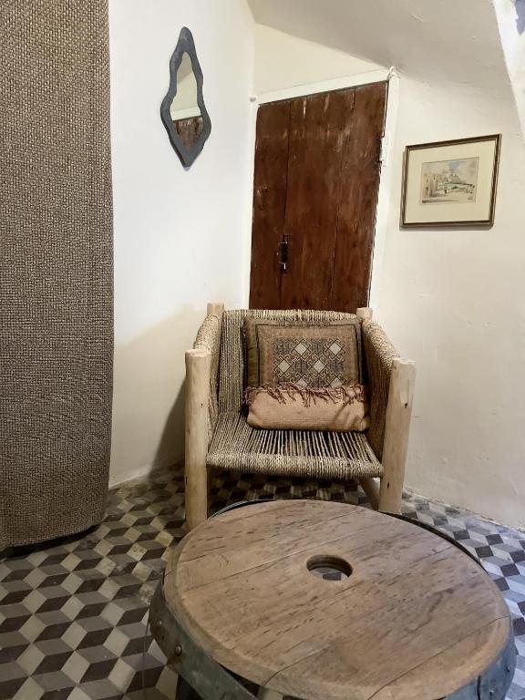 a room with a table and a chair and a door at Le Taurillou 