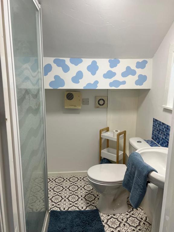 a bathroom with a shower and a toilet and a sink at Quirky Attic Blackpool in Blackpool