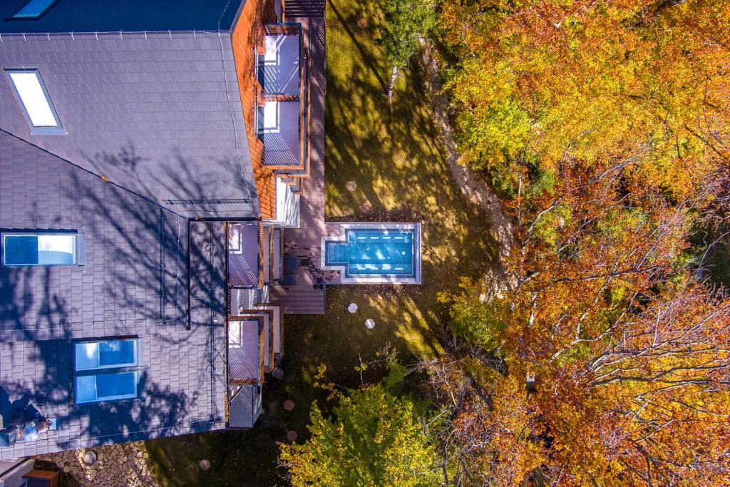 an overhead view of a house with trees at Hotel Bergo Resort & SPA in Szklarska Poręba