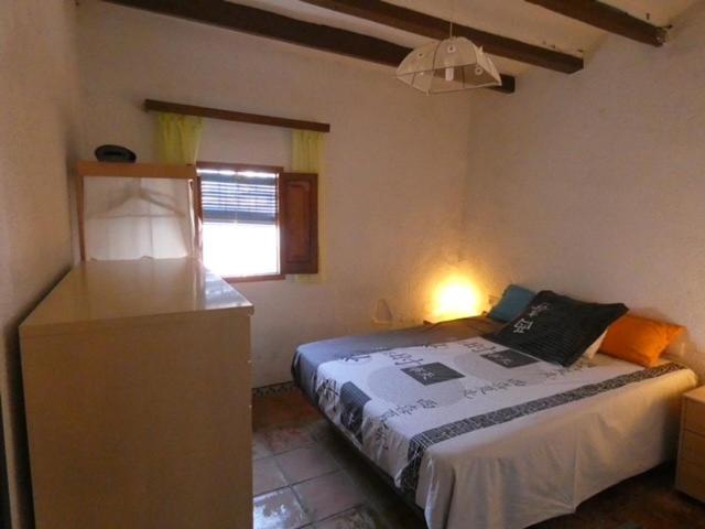 a bedroom with a bed and a window at Casa de Pueblo - Costa Blanca in Oliva