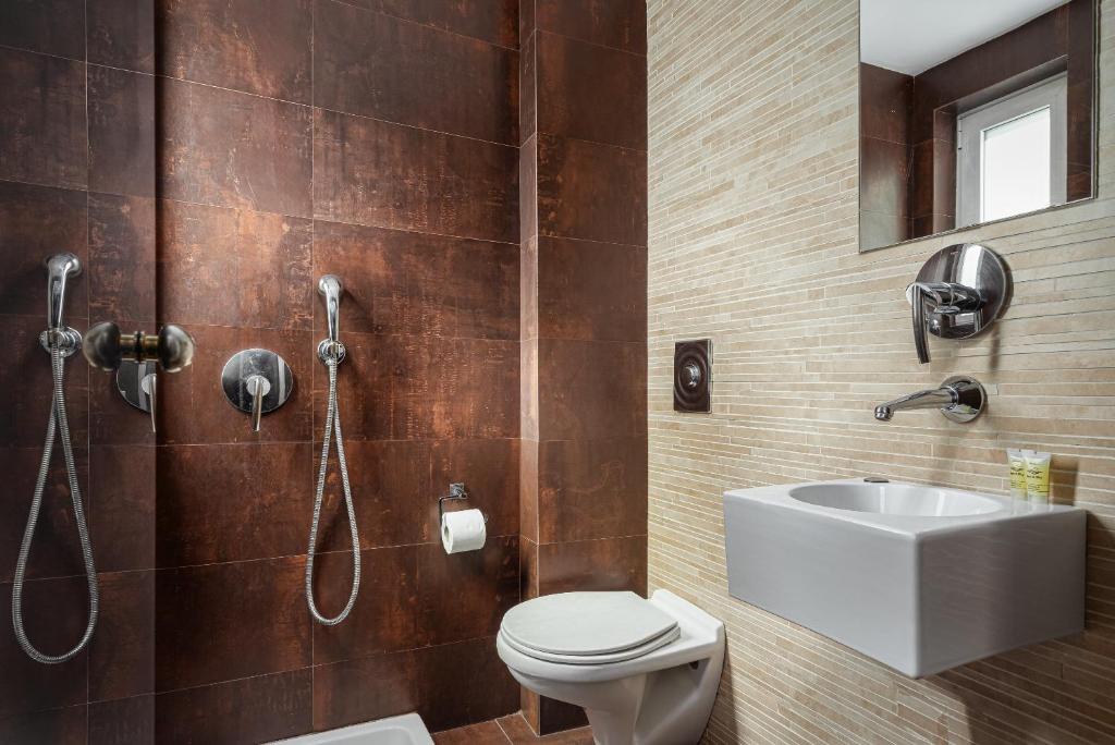 a bathroom with a shower and a toilet and a sink at Lacoba Hotel in Athens