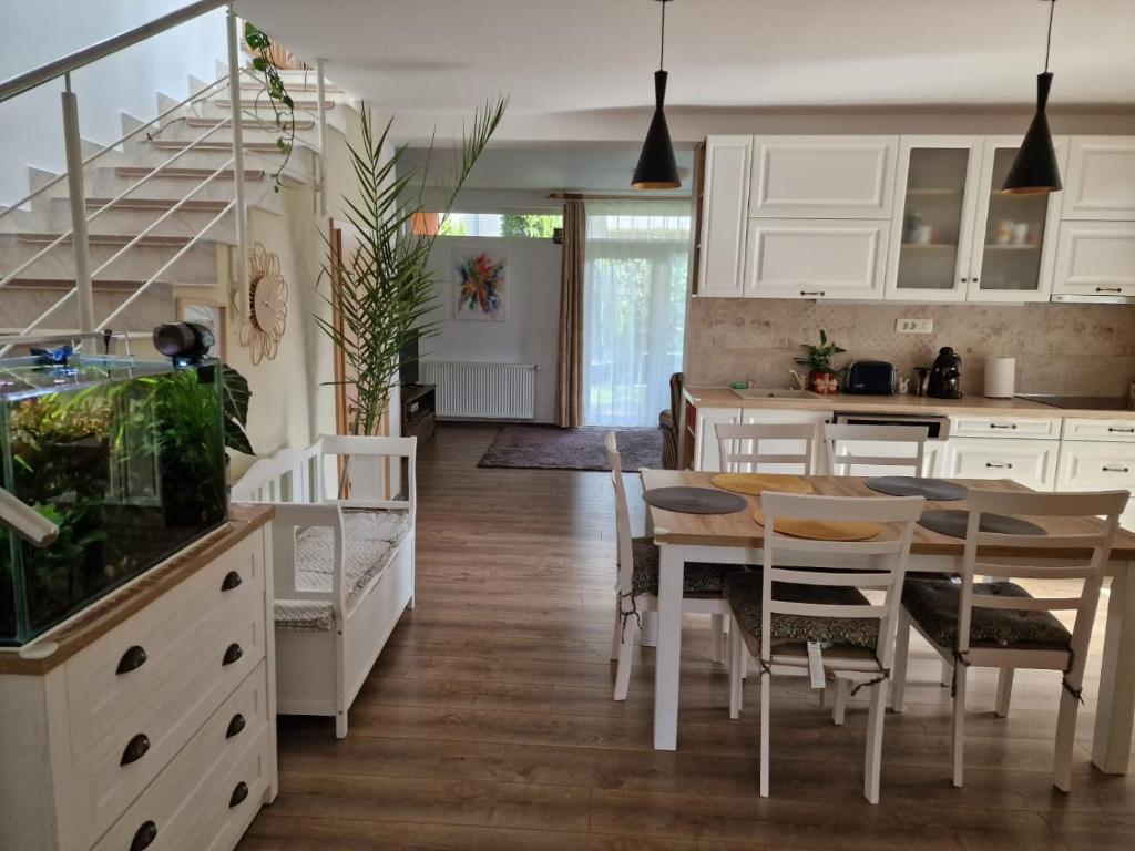 a kitchen and dining room with a table and chairs at Harmony Haven in Cluj-Napoca