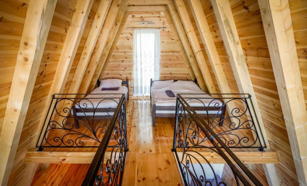 two beds in a room in a log cabin at Peace of mind in Žabljak