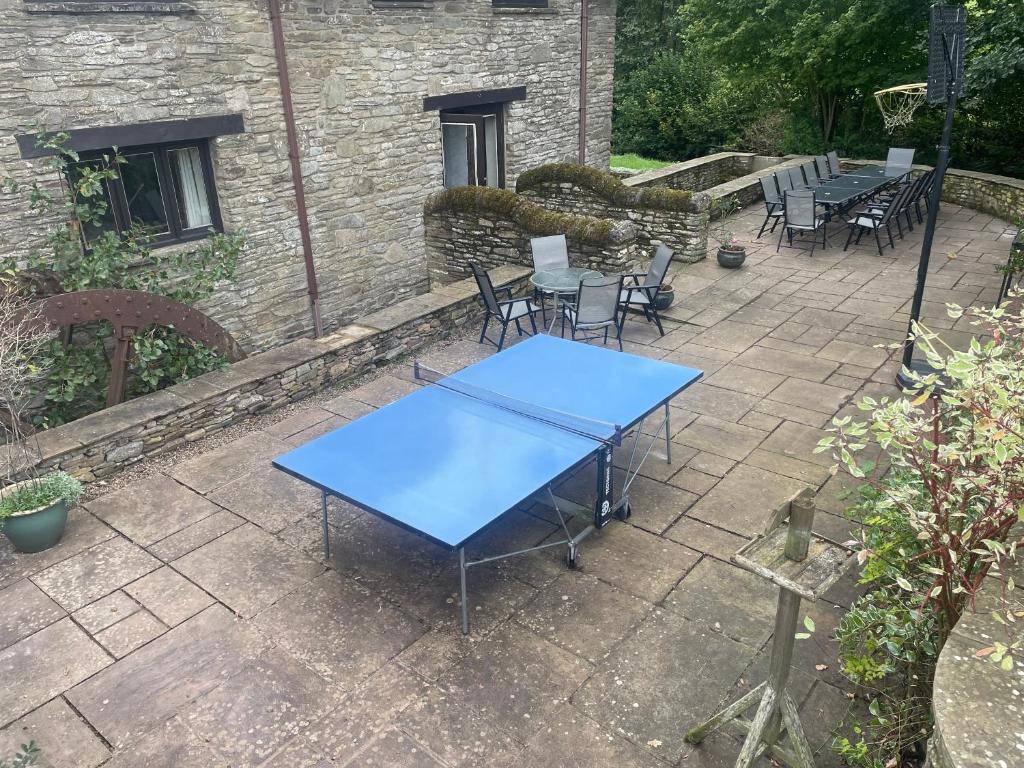 a blue table and chairs on a patio at Trebarried Mill in Brecon
