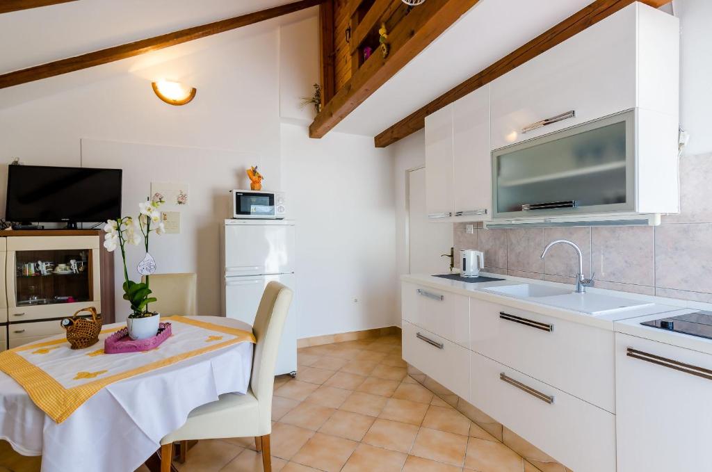a kitchen with a table and a sink and a counter at Apartment Marina View in Dubrovnik