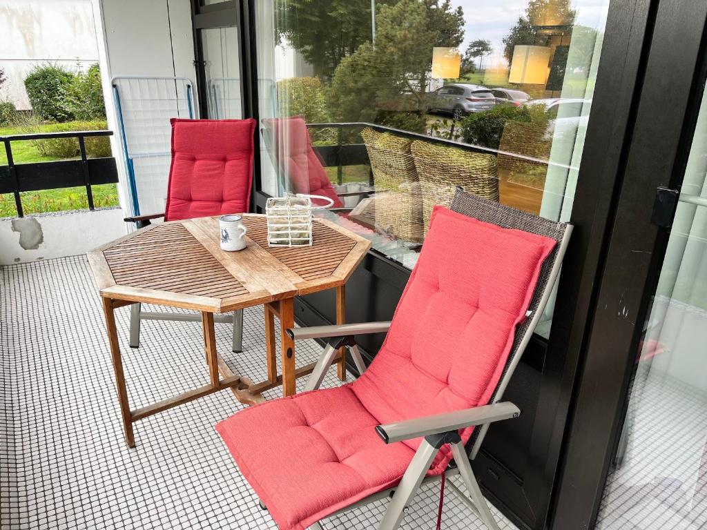 un patio avec une table et des chaises sur un balcon dans l'établissement Prinzenhof, Whg 2, à Grömitz