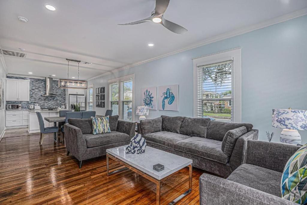 a living room with a couch and a table at Luxury Designer Villa by the Beach Bright Beautiful Brand New in Galveston