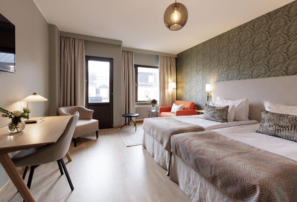 Postel nebo postele na pokoji v ubytování Home Hotel Wellington