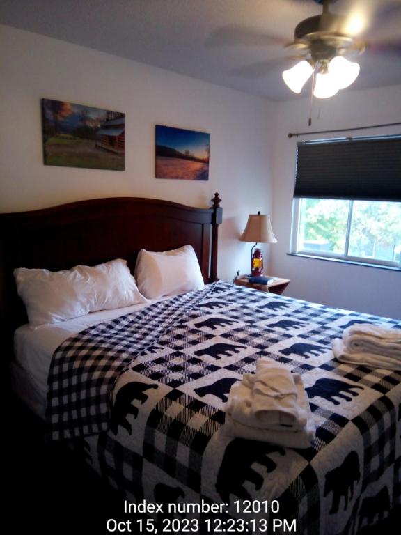 a bedroom with a bed with a black and white blanket at Gatlinburg Mountain Condo in Gatlinburg