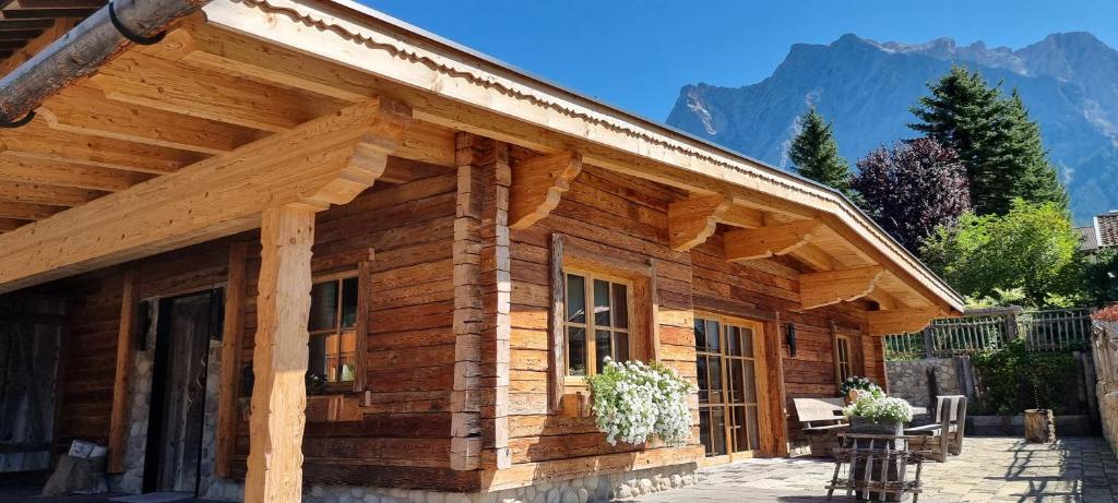 a log cabin with mountains in the background at Chalet Zugspitztraum in Ehrwald