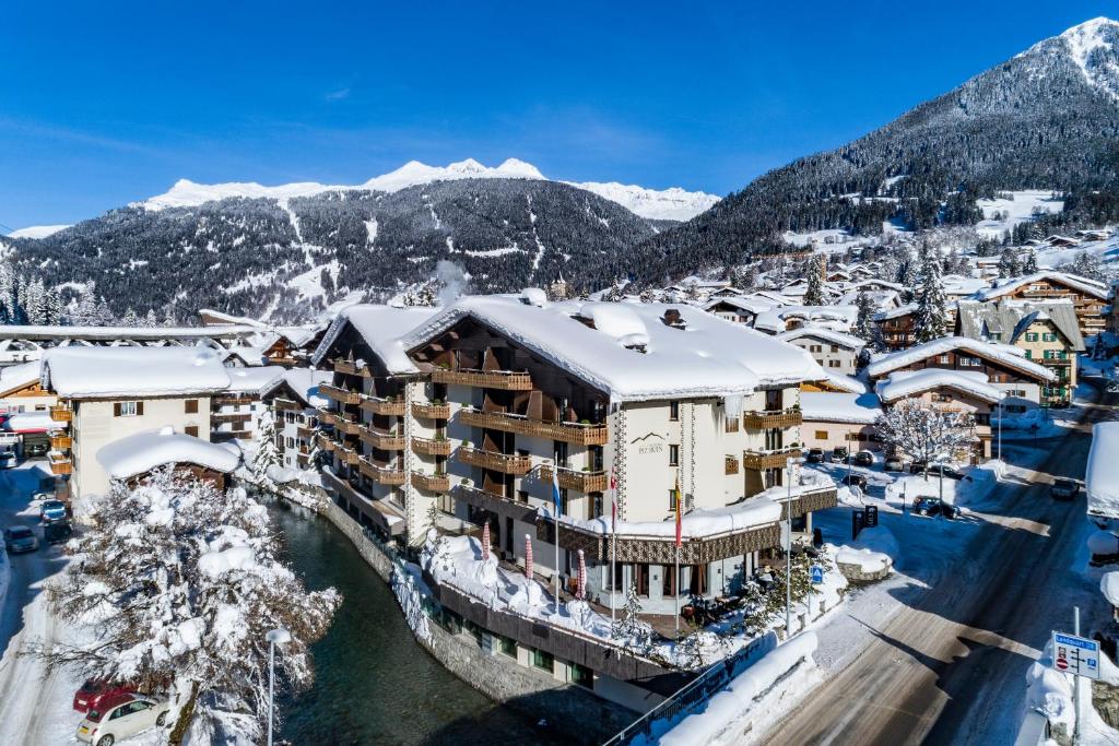 an aerial view of a resort with snow covered mountains at Hotel Piz Buin Klosters in Klosters