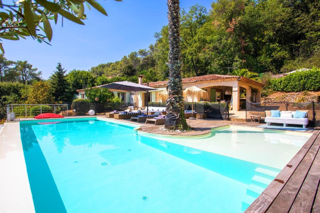 - une grande piscine dans une cour avec une maison dans l'établissement VILLA DES PARFUMS VI4382 By RIVIERA HOLIDAY HOMES, à Tourrettes-sur-Loup