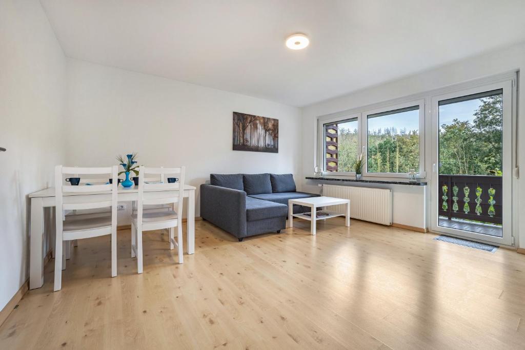 a living room with a couch and a table at Ferienwohnung Große in Osterode