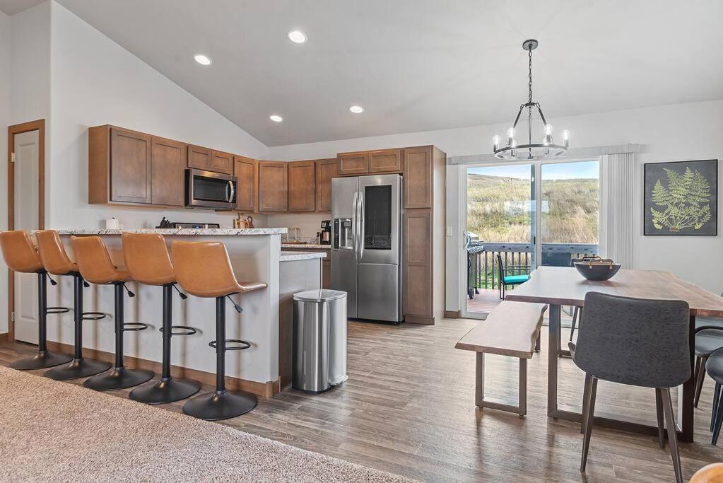 a kitchen and dining room with a table and chairs at Hill's View Retreat on the Edge of the Prairie in Rapid City